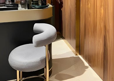 Elegant reception chair with wooden wall at The Outré, Riyadh, Riyadh Province, SA.