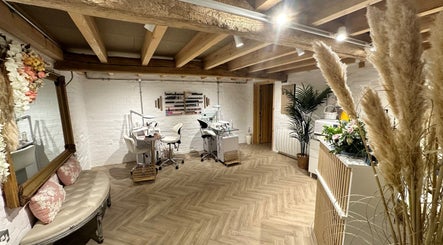 Chic nail salon interior at Nails by Nadiia, Ashbourne, England, GB featuring cozy seating and nail stations.