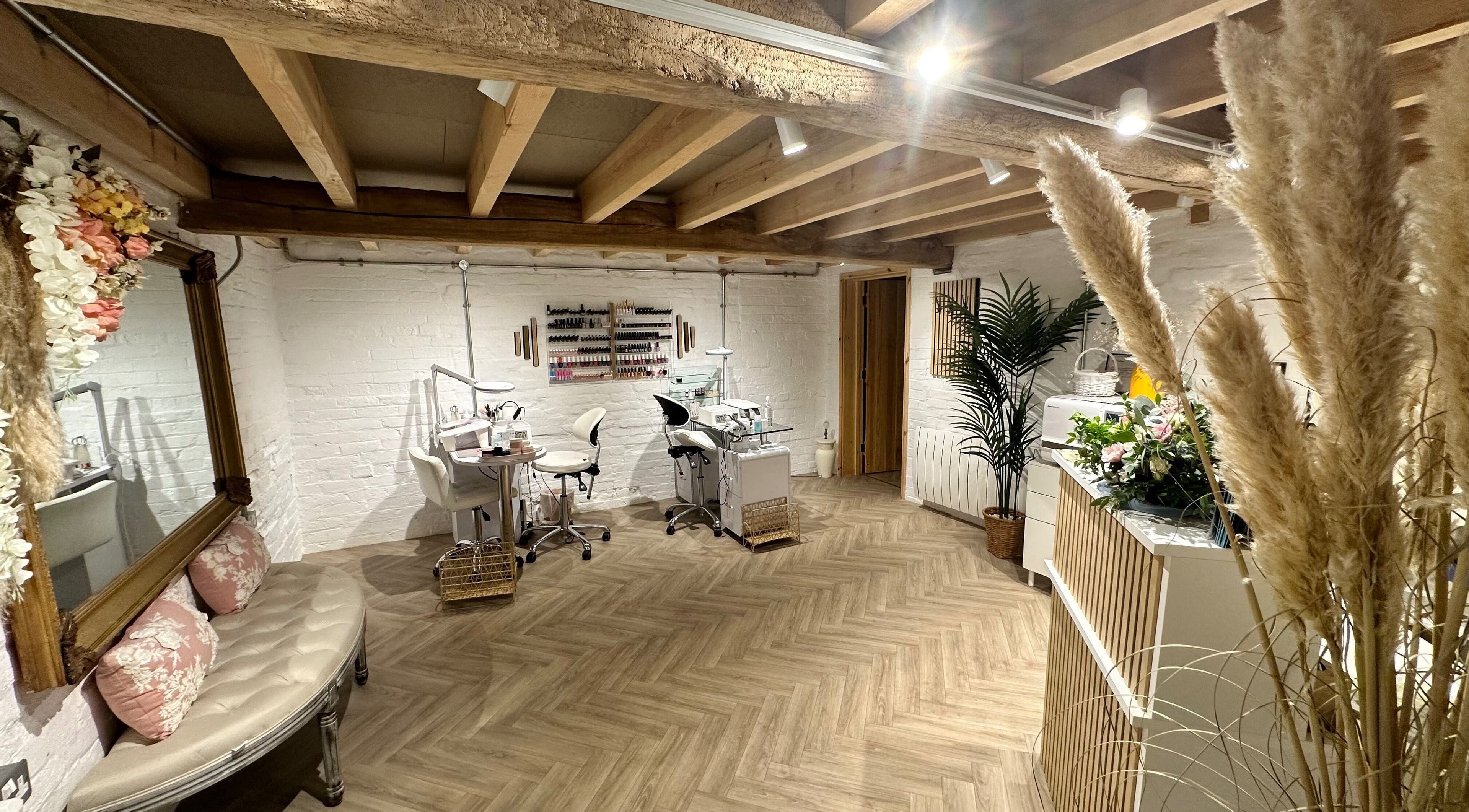 Chic nail salon interior at Nails by Nadiia, Ashbourne, England, GB featuring cozy seating and nail stations.