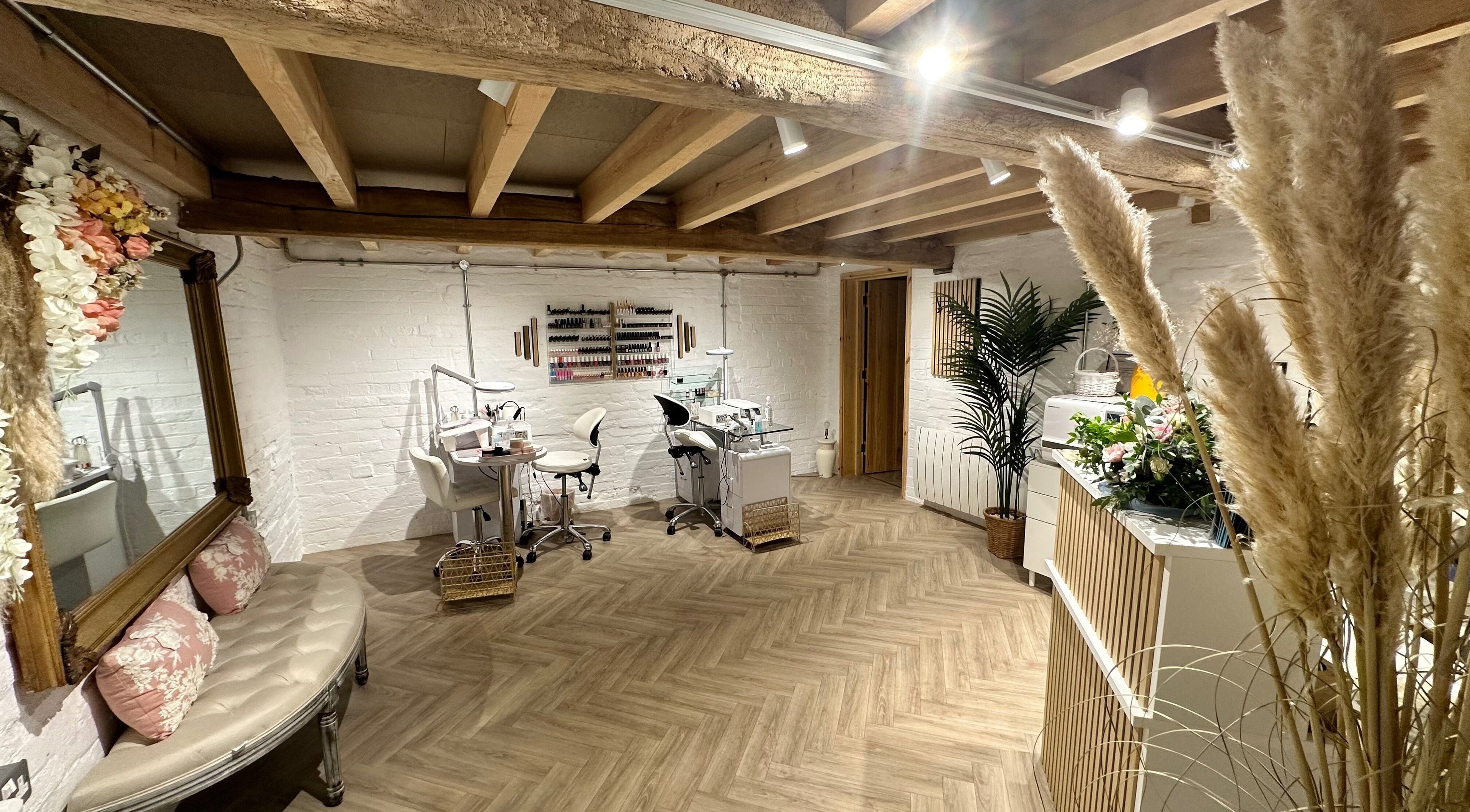 Chic nail salon interior at Nails by Nadiia, Ashbourne, England, GB featuring cozy seating and nail stations.