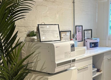 Relaxing salon corner at Nails by Nadiia, Ashbourne, England, GB with greenery and diplomas.