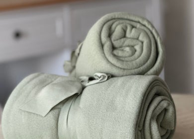 Soft green towels rolled at Nails by Nadiia, Ashbourne, England, GB, enhancing serene spa ambiance.