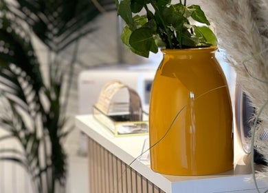 Stylish yellow vase and greenery at Nails by Nadiia, Ashbourne, England, GB. Inviting atmosphere for relaxation.