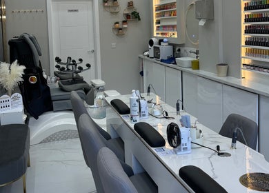 Modern nail salon interior at Happy Nails, Bromley, England, GB with sleek manicure stations and cozy seating.