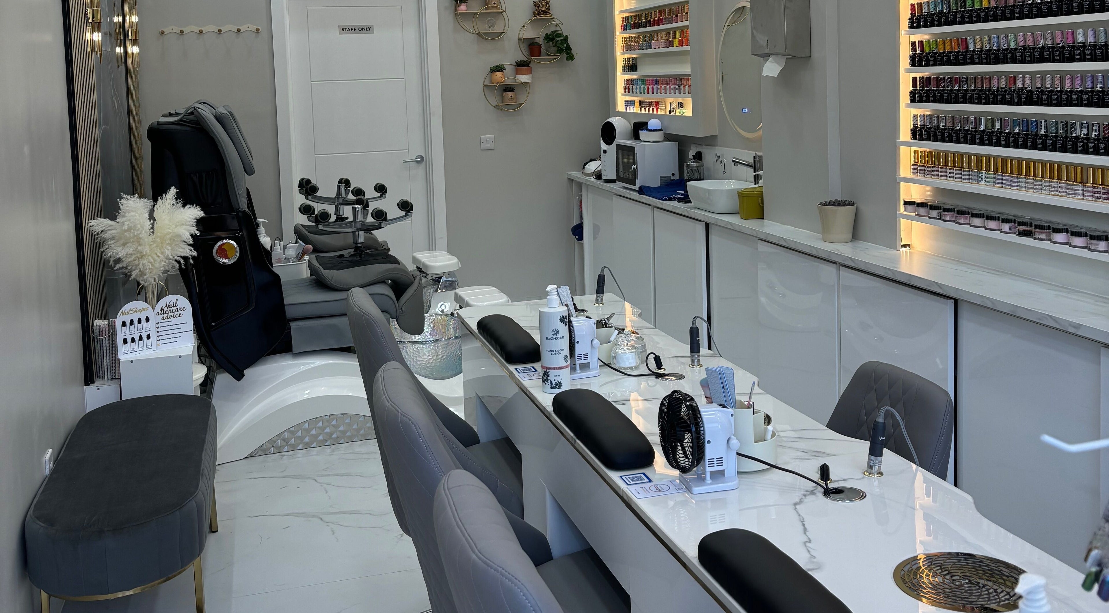 Modern nail salon interior at Happy Nails, Bromley, England, GB with sleek manicure stations and cozy seating.