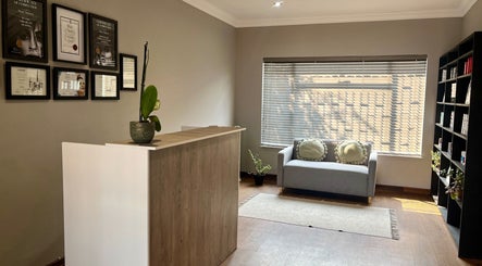 Inviting reception at Haze Aesthetics, Centurion, Gauteng, ZA with seating and certificates on display.