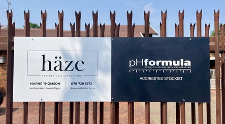 Haze Aesthetics sign displayed at entrance in Centurion, Gauteng, ZA, highlighting services and location.