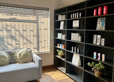 Cozy waiting area at Haze Aesthetics, Centurion, Gauteng, ZA with product display shelves and seating.