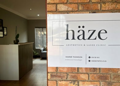 Entrance sign of Haze Aesthetics clinic in Centurion, Gauteng, ZA with modern interior glimpse.