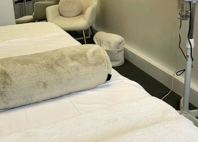 Luxurious treatment room at Skin by Cassie, Westhoughton, England, GB, featuring plush bedding and serene decor.