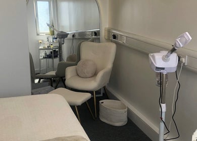 Relaxing treatment room at Skin by Cassie in Westhoughton, England, GB, featuring comfortable seating and equipment.