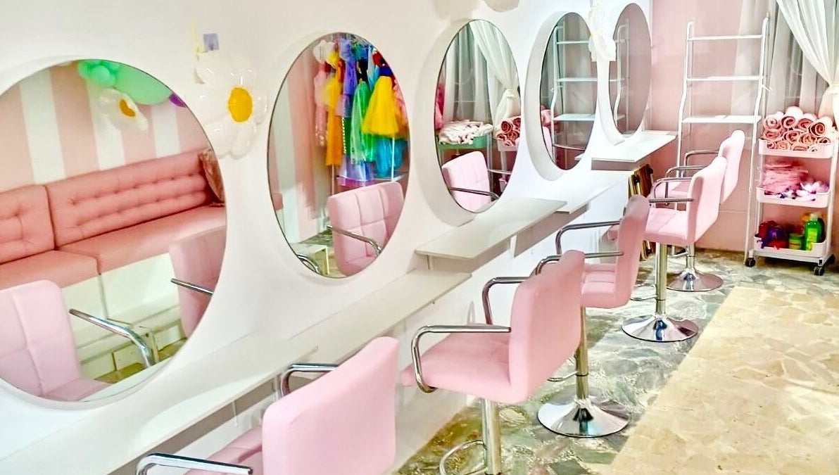 Elegant salon setup at Blueberry Locs, Lekki, Lagos, NG with pink seating and mirrors for a soothing beauty experience.
