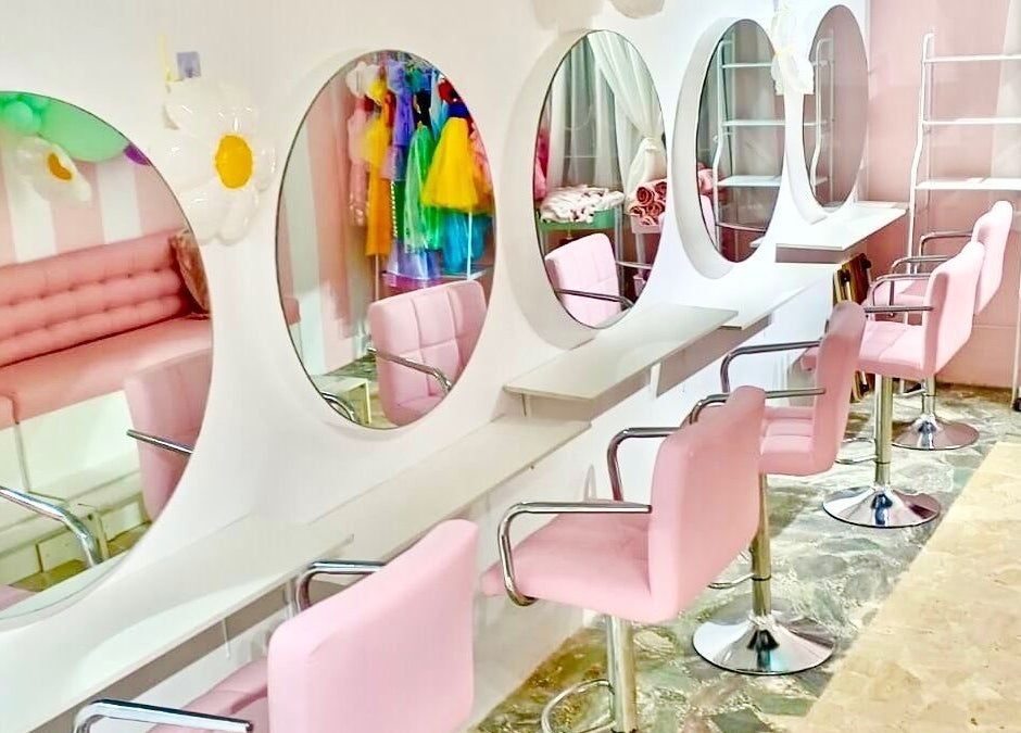 Elegant salon setup at Blueberry Locs, Lekki, Lagos, NG with pink seating and mirrors for a soothing beauty experience.