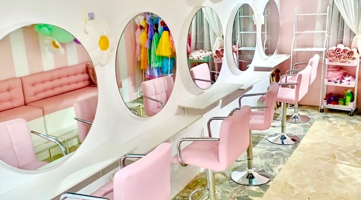 Elegant salon setup at Blueberry Locs, Lekki, Lagos, NG with pink seating and mirrors for a soothing beauty experience.