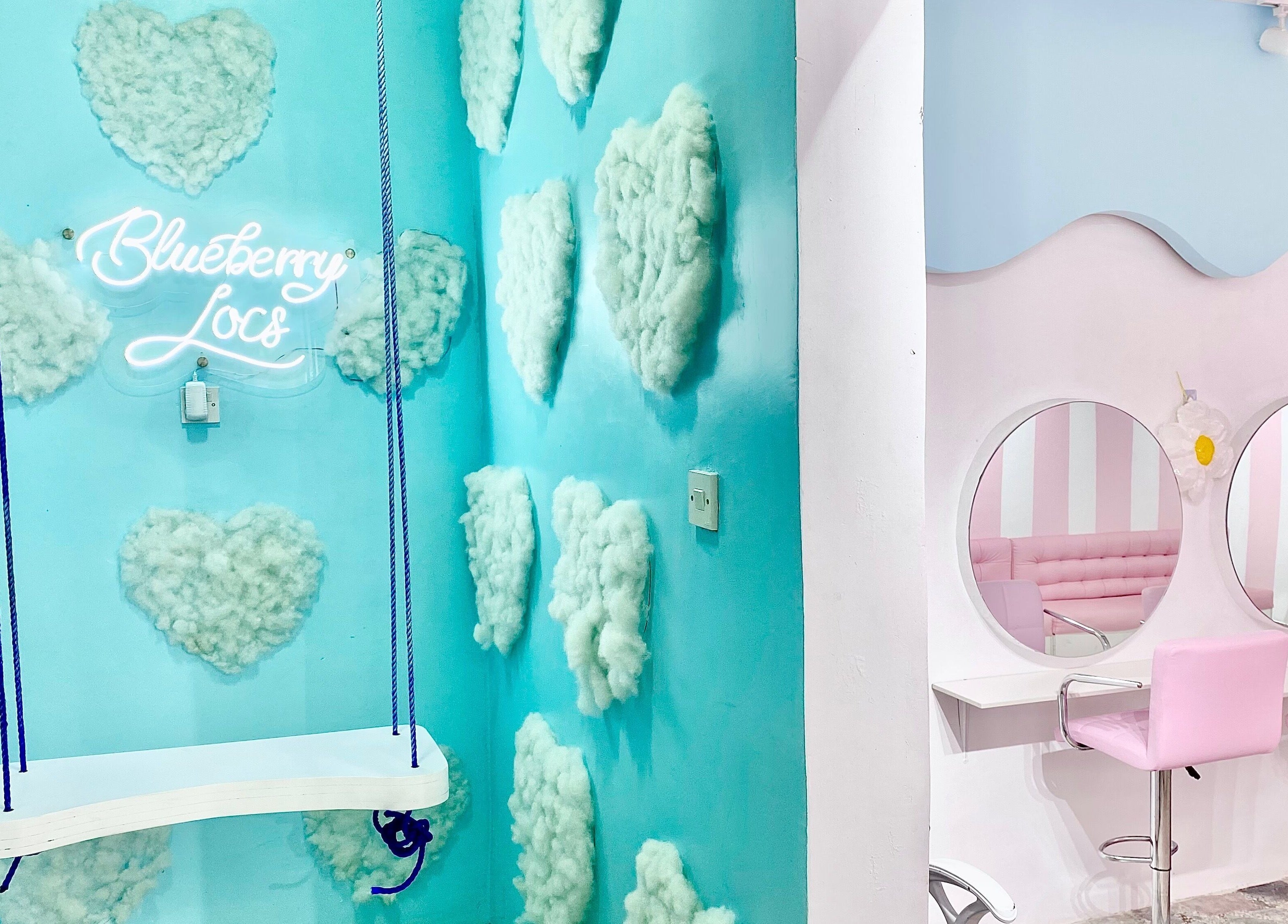Chic interior of Blueberry Locs, Lekki, Lagos, NG, featuring pastel decor and a unique swing.