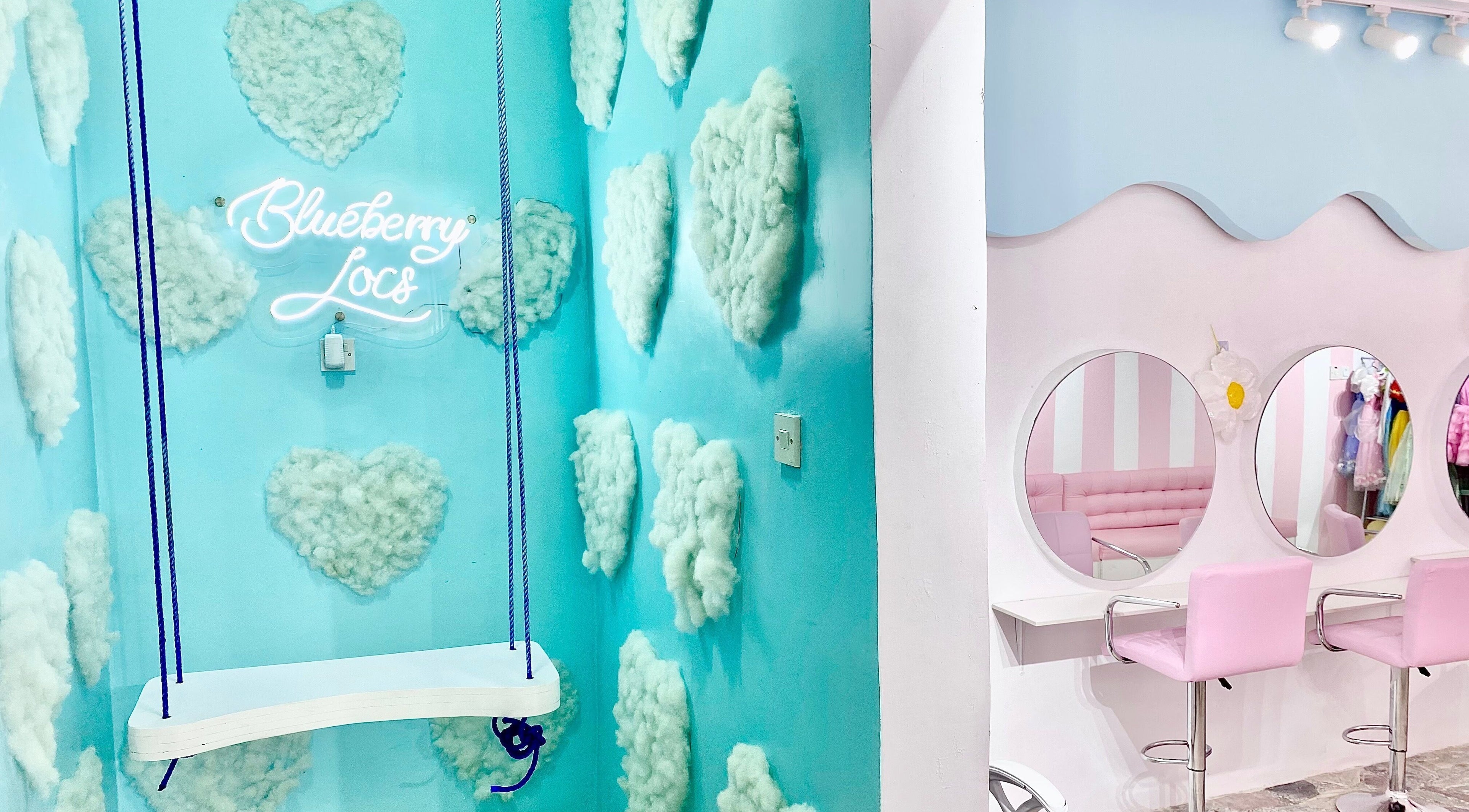 Chic interior of Blueberry Locs, Lekki, Lagos, NG, featuring pastel decor and a unique swing.