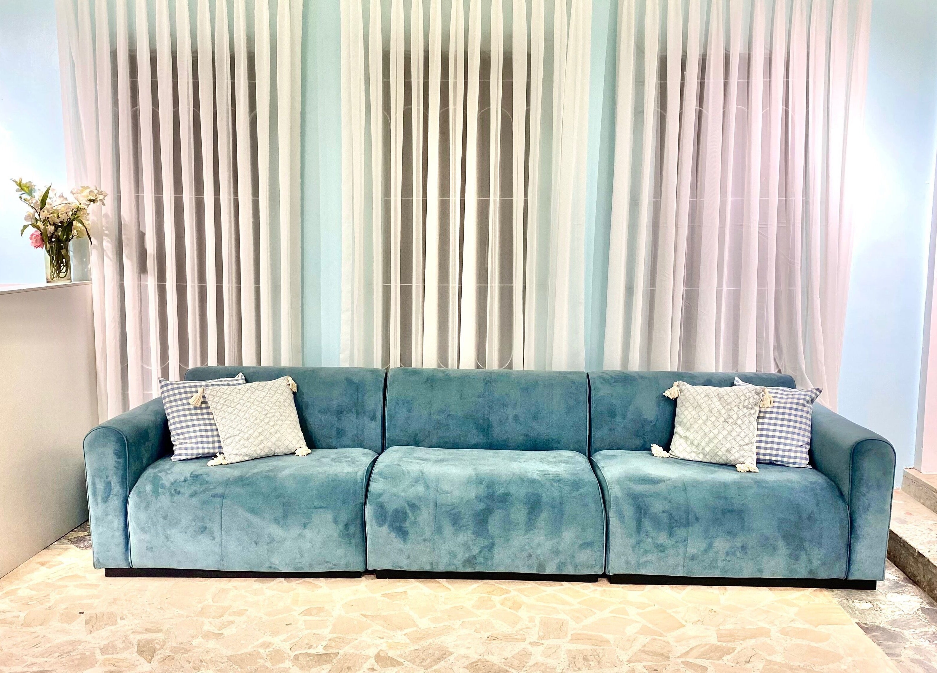 Elegant blue sofa with cushions at Blueberry Locs, Lekki, Lagos, NG, creating a peaceful ambiance.