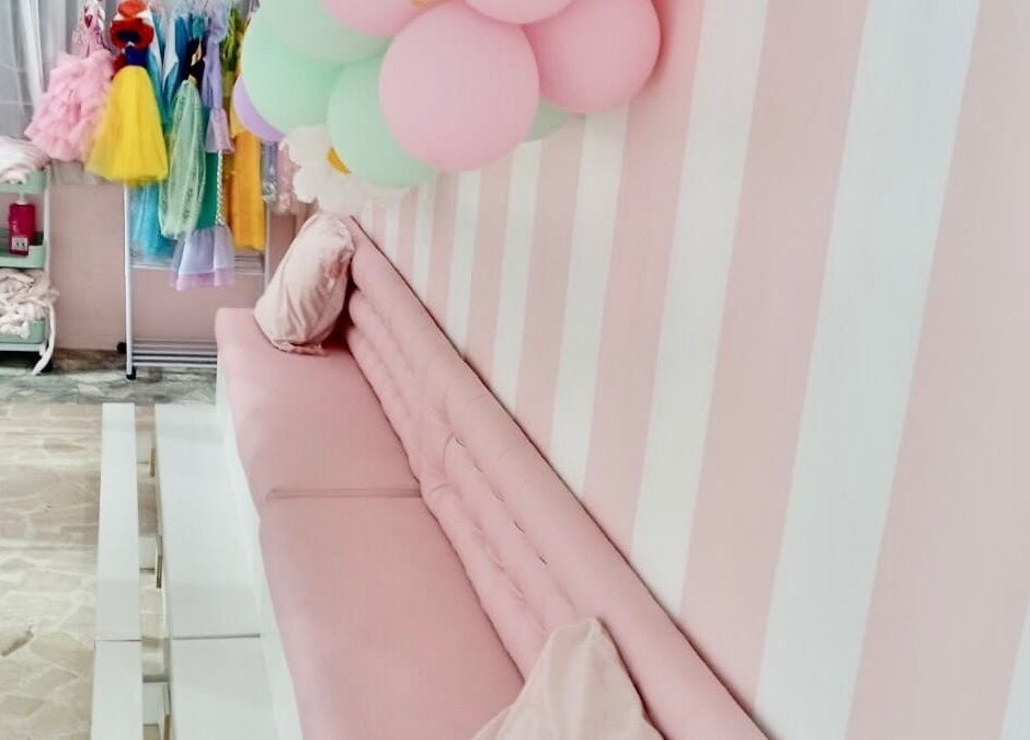 Chic pink striped seating area at Blueberry Locs, Lekki, Lagos, NG, enhancing the elegant ambiance.