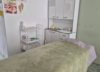 Peaceful massage room at HGbeauty, Warsop, England, GB equipped with cozy linens and relaxing candles.