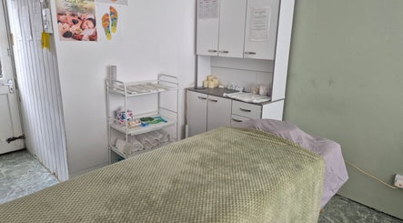 Peaceful massage room at HGbeauty, Warsop, England, GB equipped with cozy linens and relaxing candles.