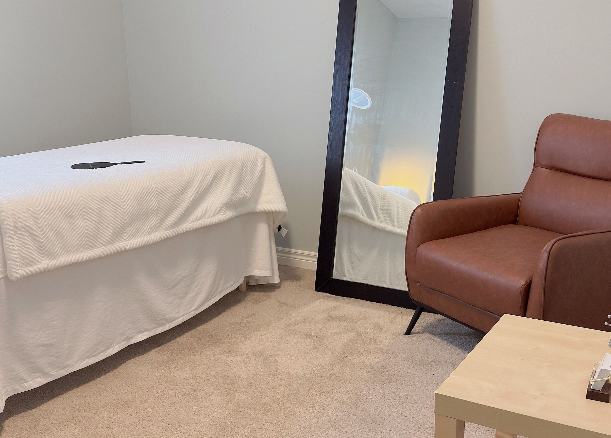 Comfortable treatment room at ✦ Vki Lash Studio ✦ in London, Ontario, CA, featuring a plush chair and mirror.