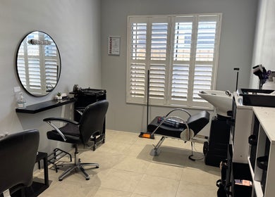 Chic beauty station at Awhair in Yanchep, Western Australia, AU, featuring a sleek chair and mirror.