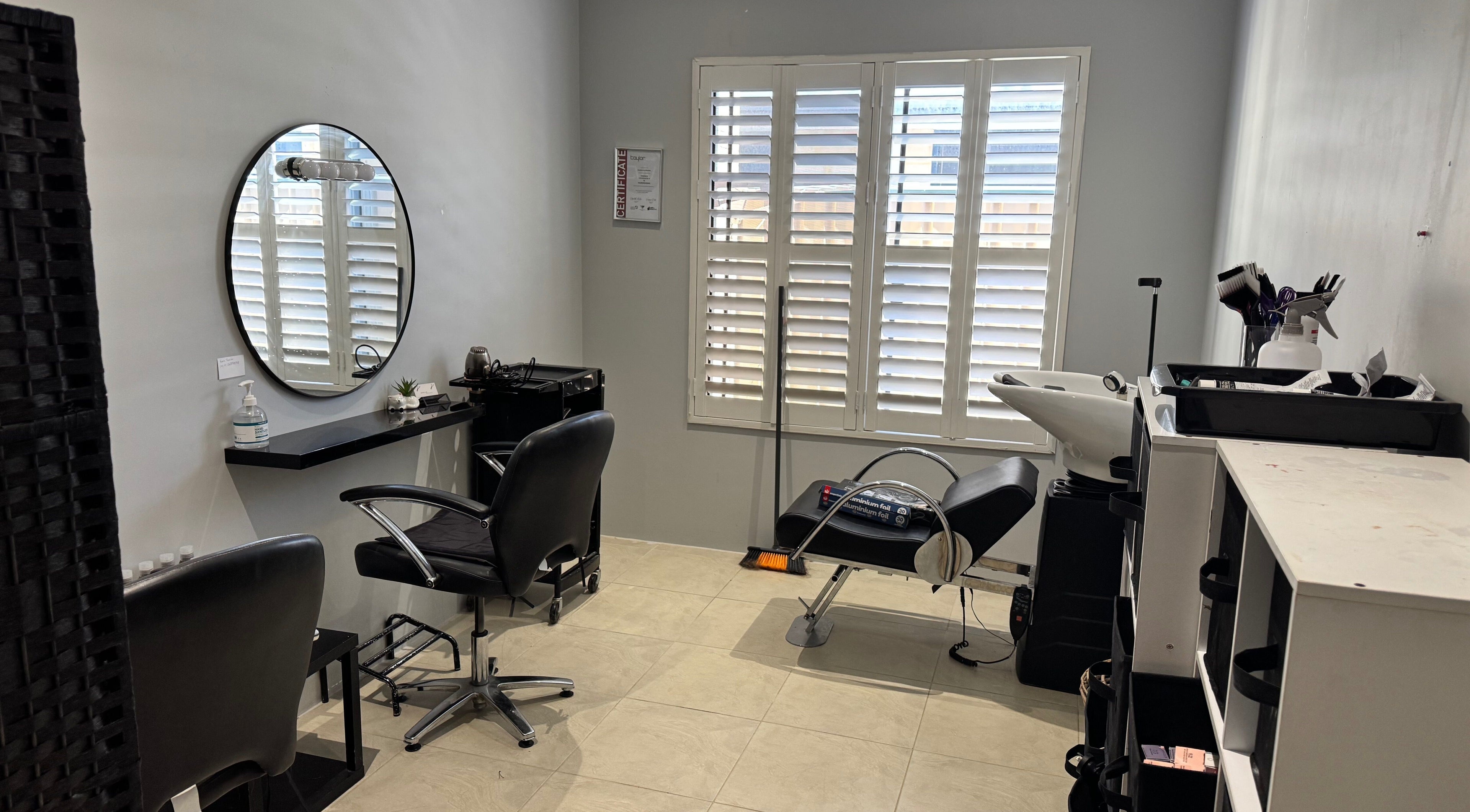 Chic beauty station at Awhair in Yanchep, Western Australia, AU, featuring a sleek chair and mirror.