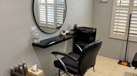 Elegant salon station at Awhair, Yanchep, Western Australia, AU, featuring sleek chair and mirror.
