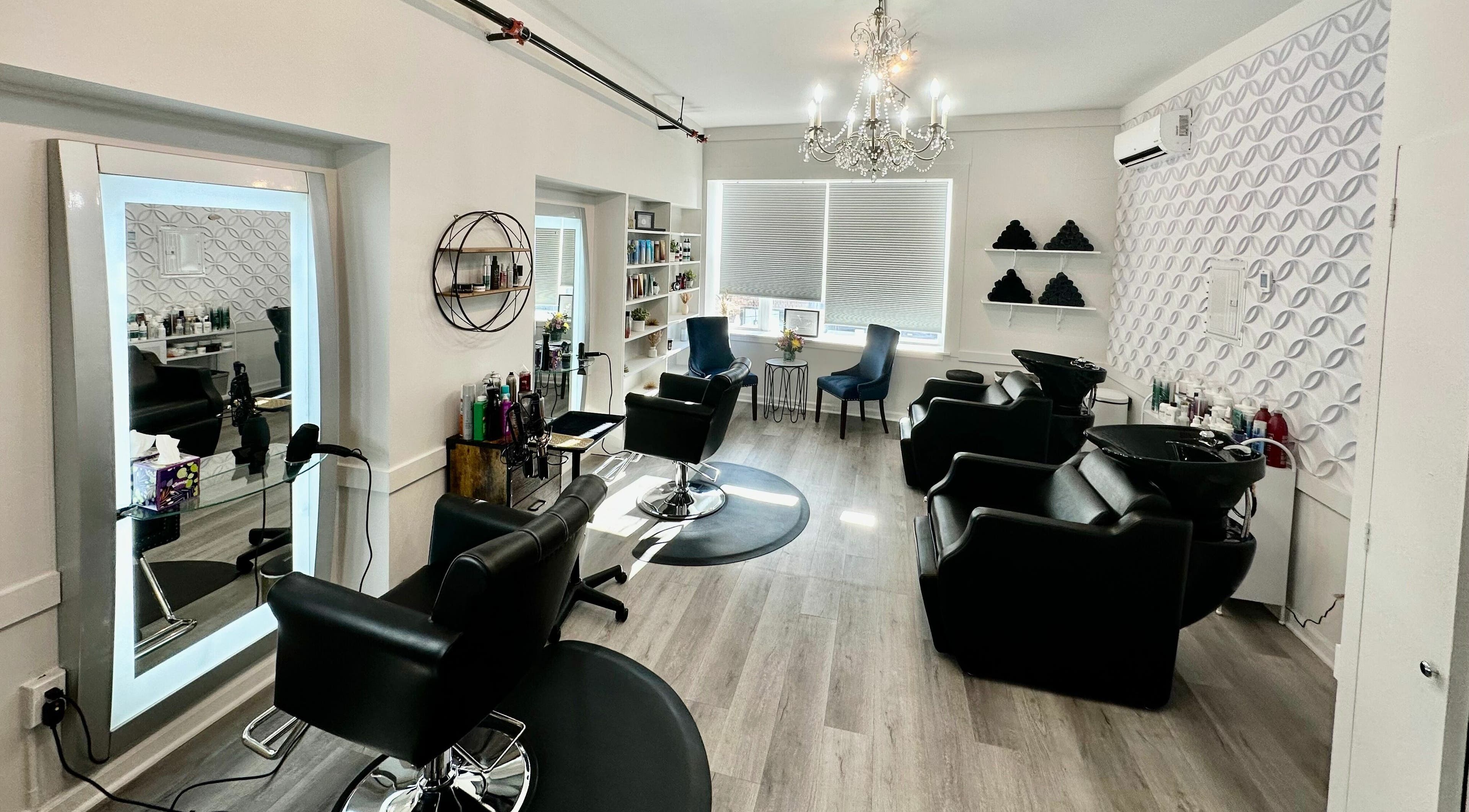 Chic interior of The Hair Artistry Studio in Harrison, New York, US, featuring stylish chairs and modern decor.