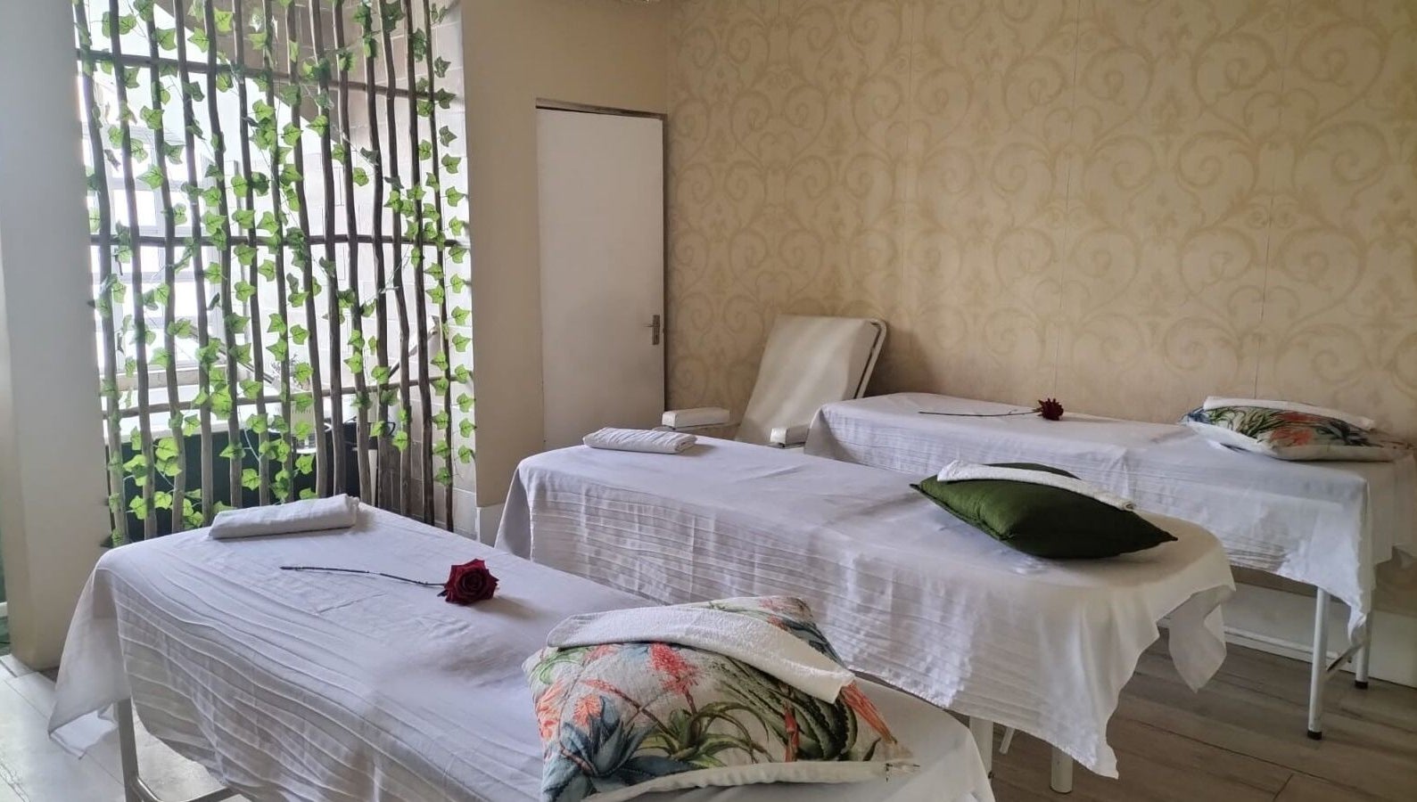 Massage beds in a tranquil room at HEAVEN ON EARTH DAY SPA, Berea, Kwazulu-natal, ZA, adorned with roses.