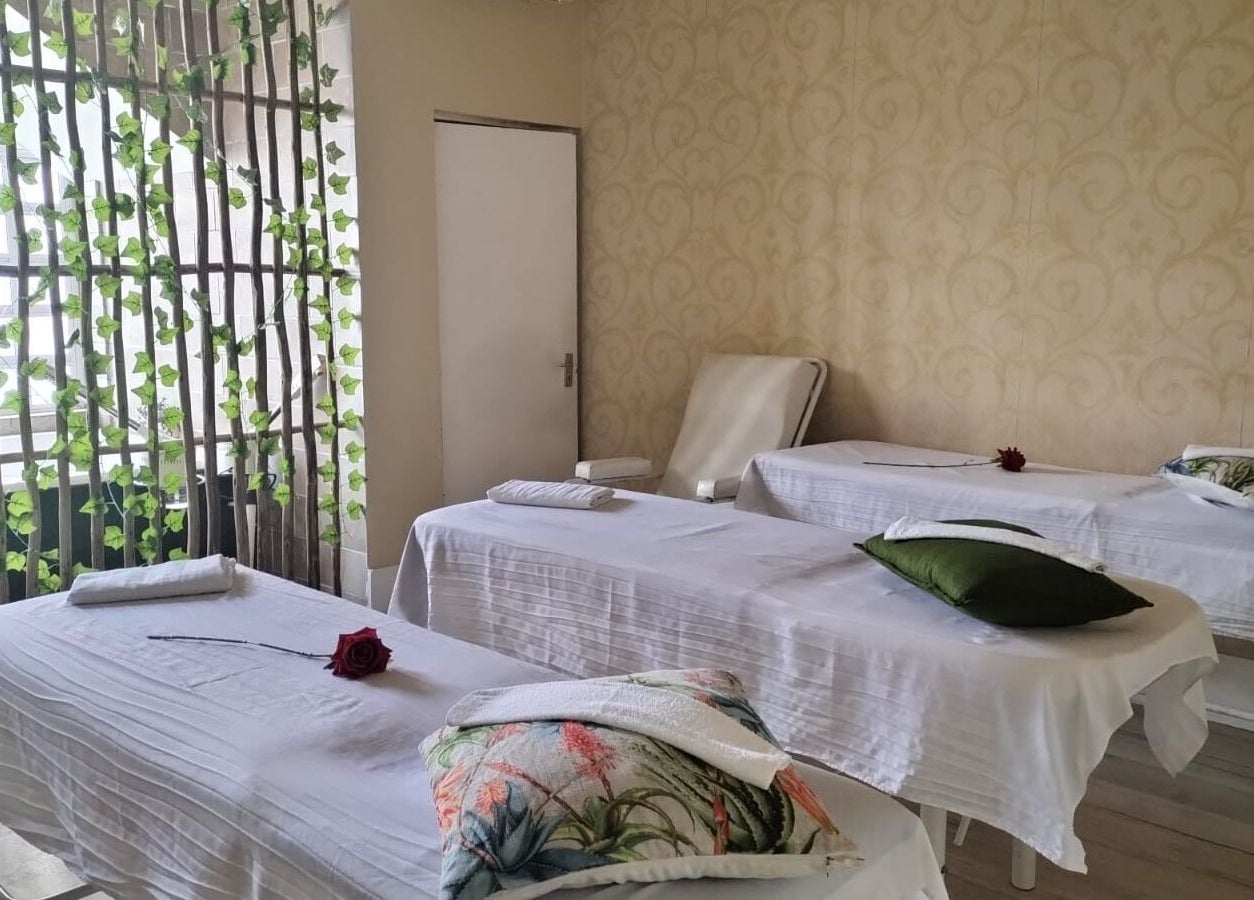 Massage beds in a tranquil room at HEAVEN ON EARTH DAY SPA, Berea, Kwazulu-natal, ZA, adorned with roses.