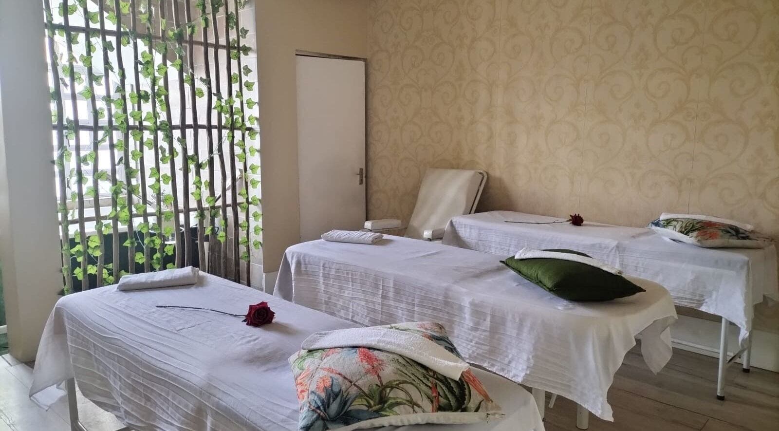 Massage beds in a tranquil room at HEAVEN ON EARTH DAY SPA, Berea, Kwazulu-natal, ZA, adorned with roses.