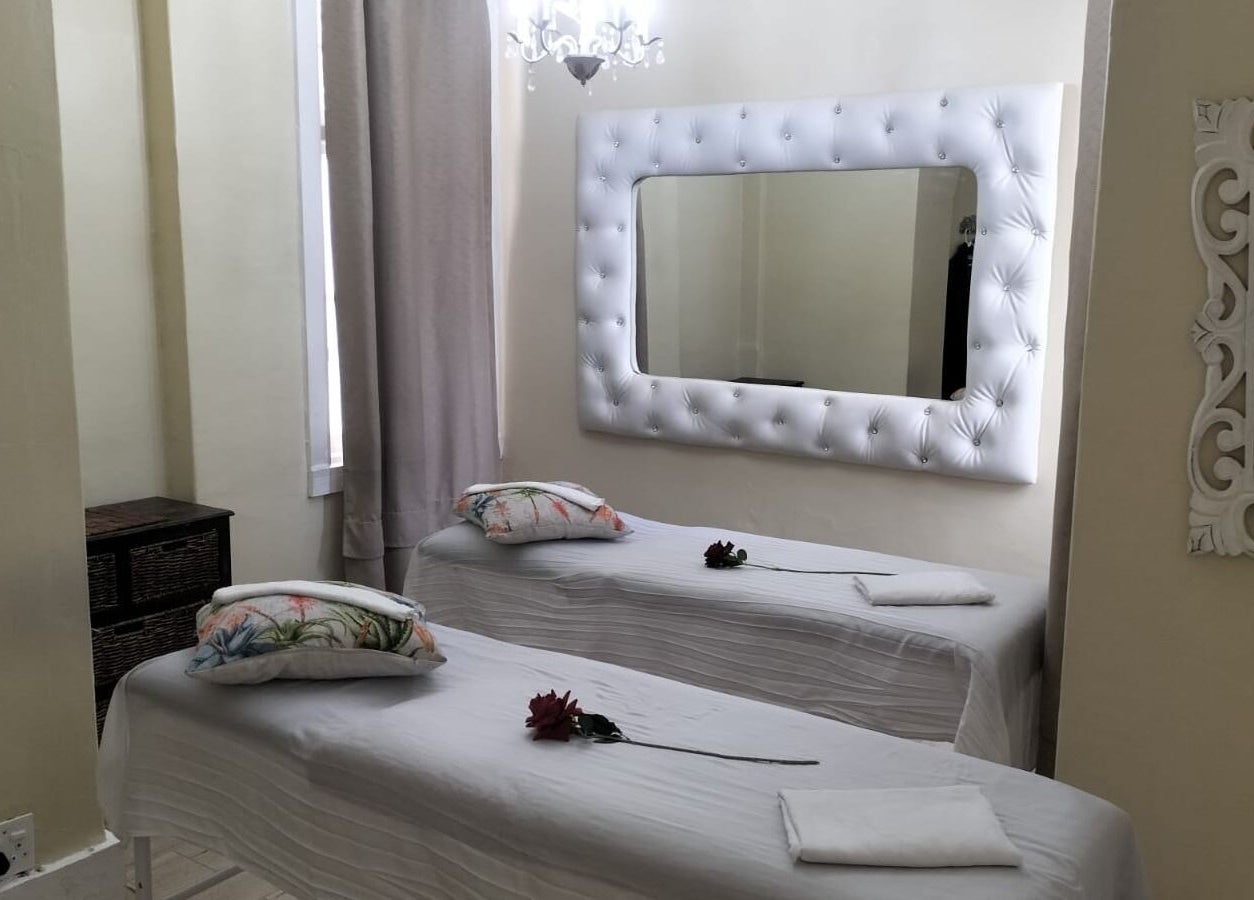 Relaxing treatment room at HEAVEN ON EARTH DAY SPA in Berea, Kwazulu-natal, ZA with decorated massage beds.