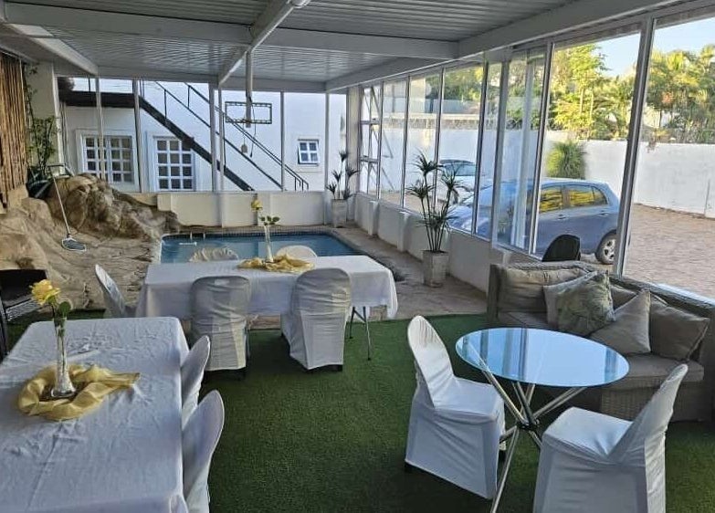 Bright indoor area at HEAVEN ON EARTH DAY SPA in Berea, Kwazulu-natal, ZA with poolside seating.