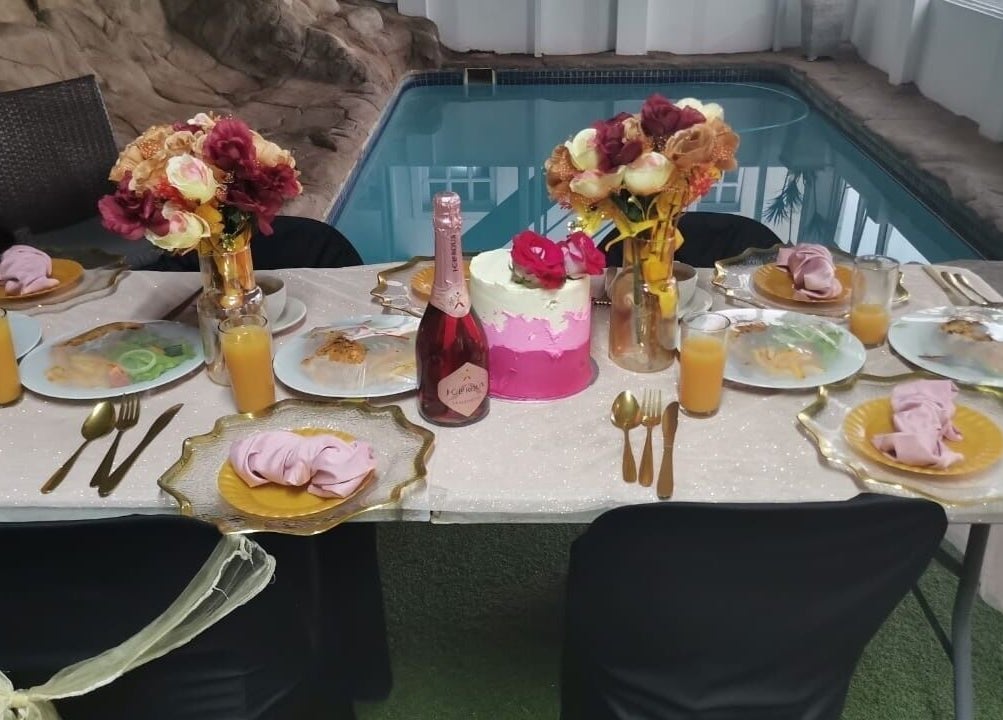Elegant table setting by the pool at HEAVEN ON EARTH DAY SPA, Berea, Kwazulu-natal, ZA, featuring vibrant decor.