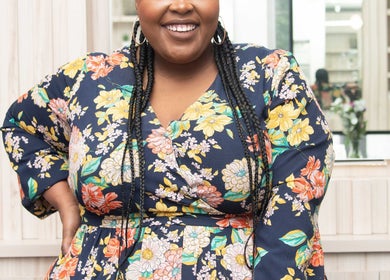 Smiling woman in floral dress at Redifine Beauty Studios, Sandton, Gauteng, ZA.