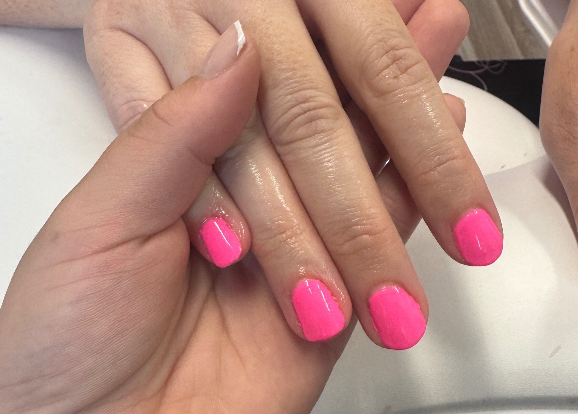 Fresh pink manicure at Beauté Bar in Dumfries, Scotland, GB, showcasing expert nail care.