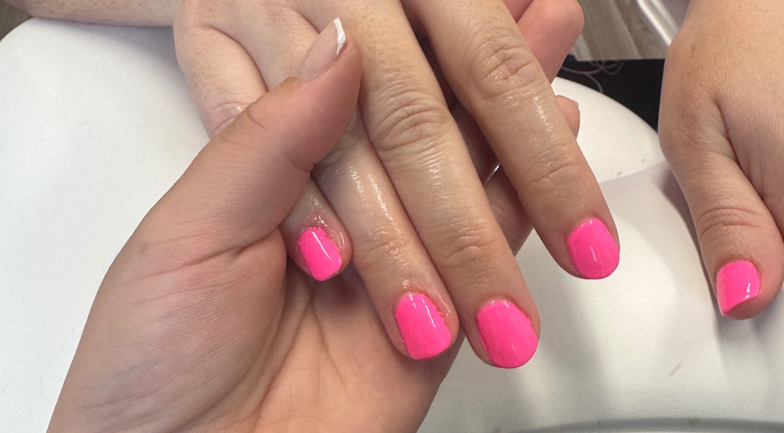 Fresh pink manicure at Beauté Bar in Dumfries, Scotland, GB, showcasing expert nail care.