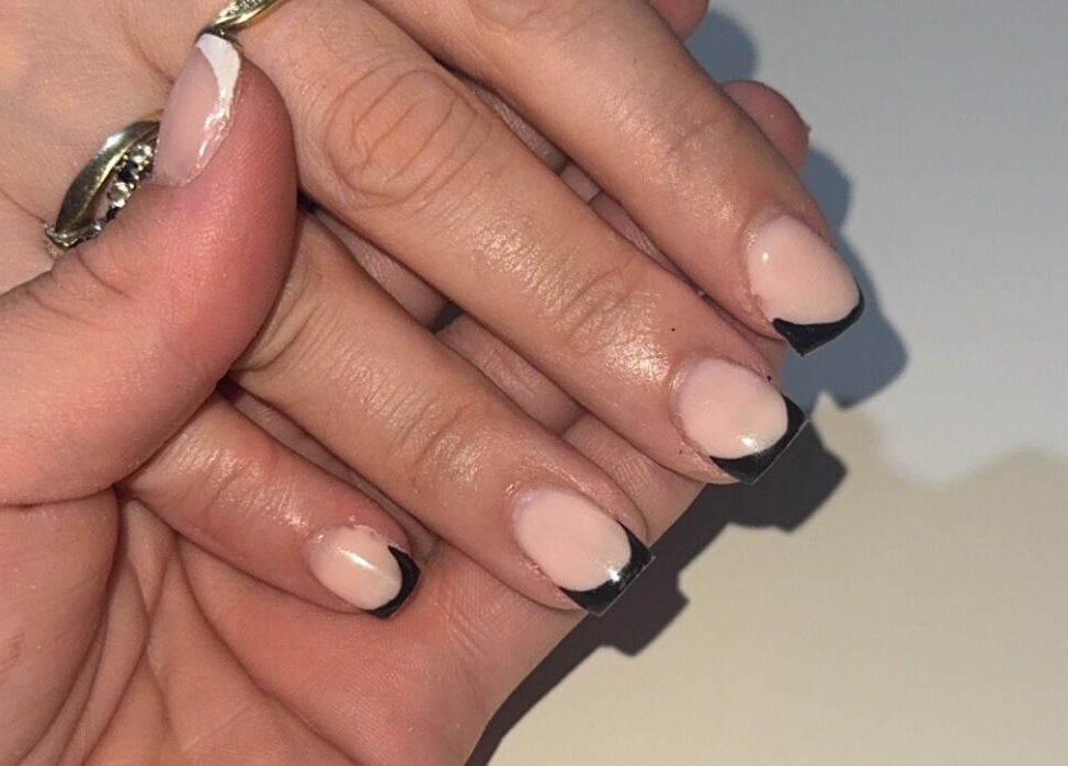 Elegant black-tipped manicure at Beauté Bar, Dumfries, Scotland, GB. Perfect for classy and modern looks.