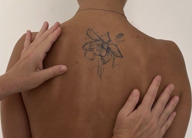 Floral back tattoo with hands at Sculptor By Aray Kairkanova Ladies Salon DUBAI MARINA, Dubai, Dubai, AE.