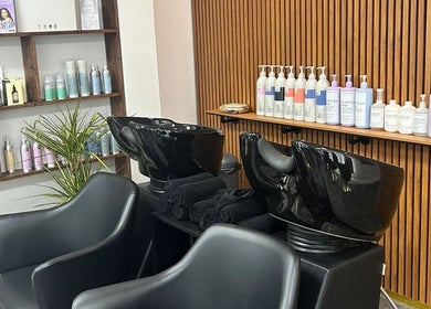 Stylish salon wash stations at L.E.V Hair & Beauty in Leicester, England, GB with premium hair care products.