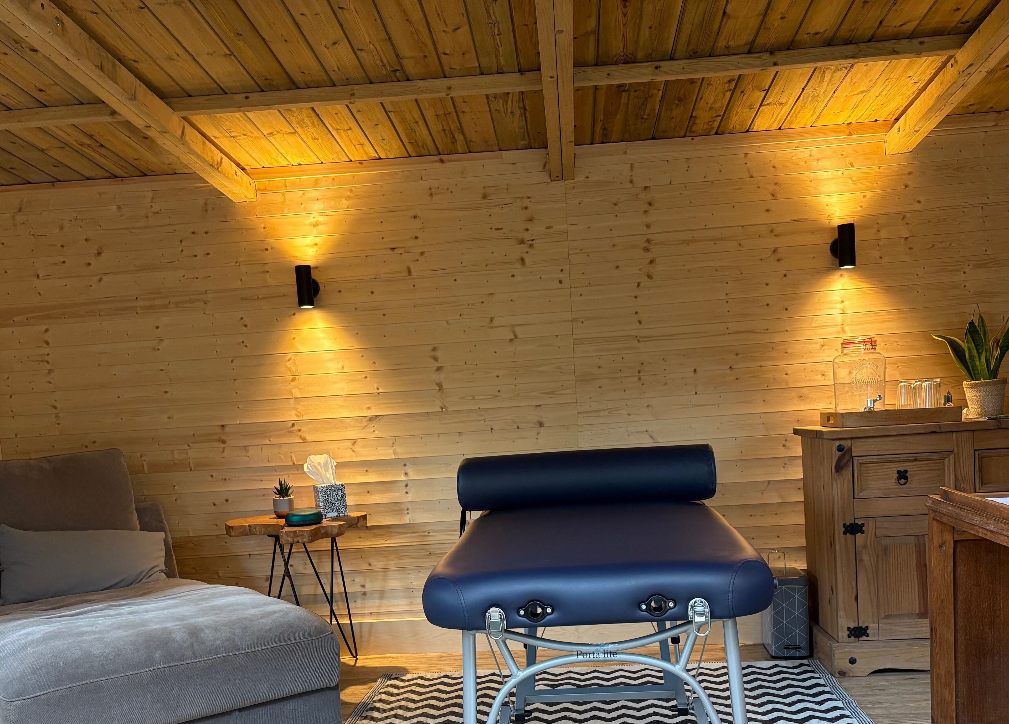 Relaxing massage room at Frequency Health, Saint Leonard’s on Sea, England, GB, featuring cozy decor.