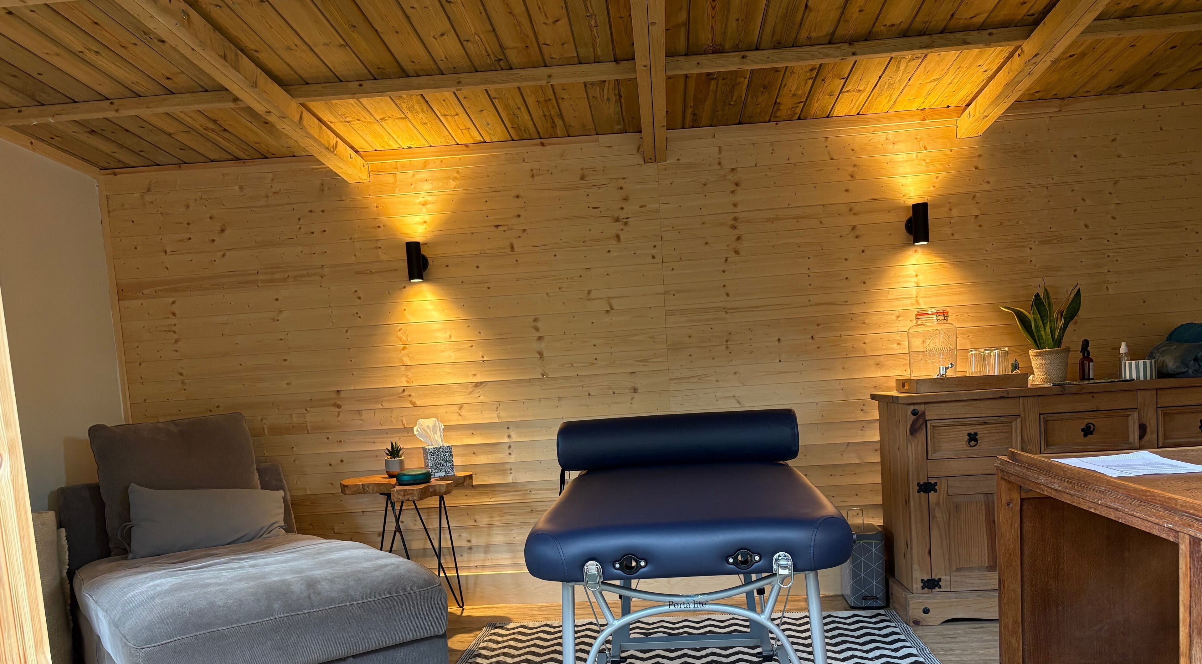Relaxing massage room at Frequency Health, Saint Leonard’s on Sea, England, GB, featuring cozy decor.