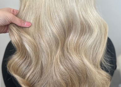 Blonde wavy hairstyle at Hair By Ellie Marie, Droitwich Spa, England, GB, highlighting silky hair texture.