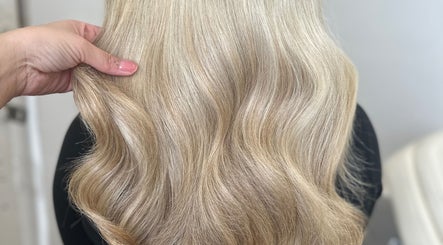 Blonde wavy hairstyle at Hair By Ellie Marie, Droitwich Spa, England, GB, highlighting silky hair texture.