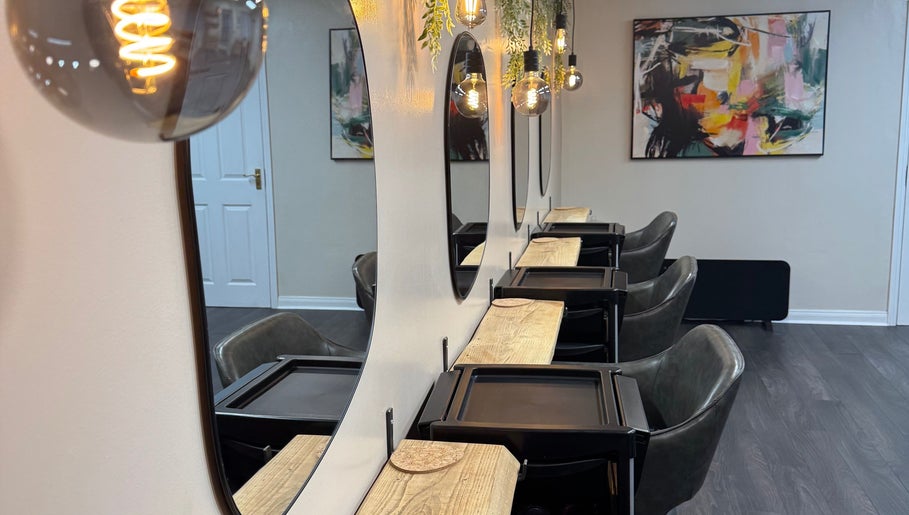 Elegant styling area at South Beach Salon, Helston, England, GB with modern decor and ambient lighting.