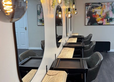 Elegant styling area at South Beach Salon, Helston, England, GB with modern decor and ambient lighting.