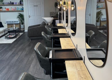 Modern interior of South Beach Salon, Helston, England, GB with plush seating and styling stations.