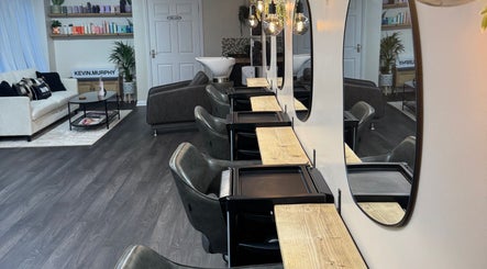 Modern interior of South Beach Salon, Helston, England, GB with plush seating and styling stations.