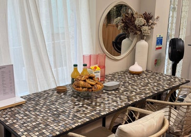 Inviting table setup at South Beach Salon, Helston, England, GB, featuring pastries and refreshments.